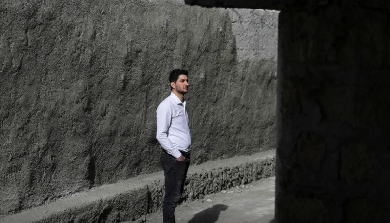 Abdel Hamid al-Youssef, an internally displaced man who says his wife and infant twins were killed when poison gas was dropped on their home town of Khan Sheikhoun in 2017, stands outside his house in the opposition-held town of Sarmada in Idlib province, Syria April 1, 2022. Picture taken April 1, 2022. REUTERS/Khalil Ashawi
