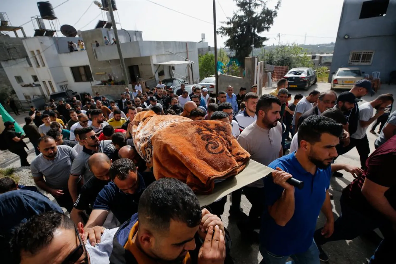 People carry the body of Palestinian woman Ghada Sabatin, who medics said was killed by Israeli forces, during her funeral in Husan in the Israeli-occupied West Bank April 10, 2022. REUTERS/Mussa Qawasma