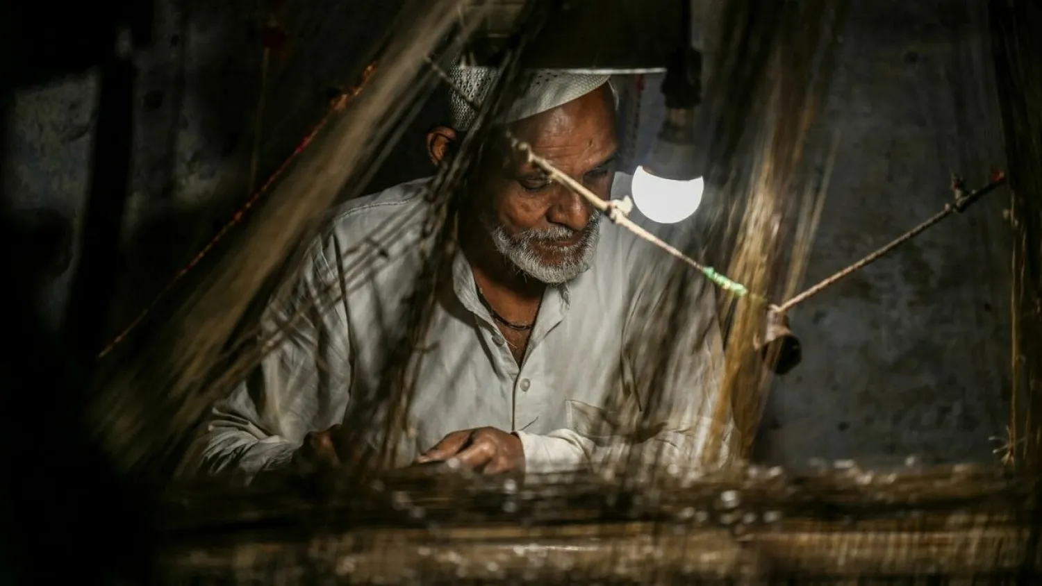 In a dim room near the banks of India's Ganges river, arms glide over a creaking loom as another silken fiber is guided into place with the rhythmic clack of a wooden beam. Money SHARMA AFP
