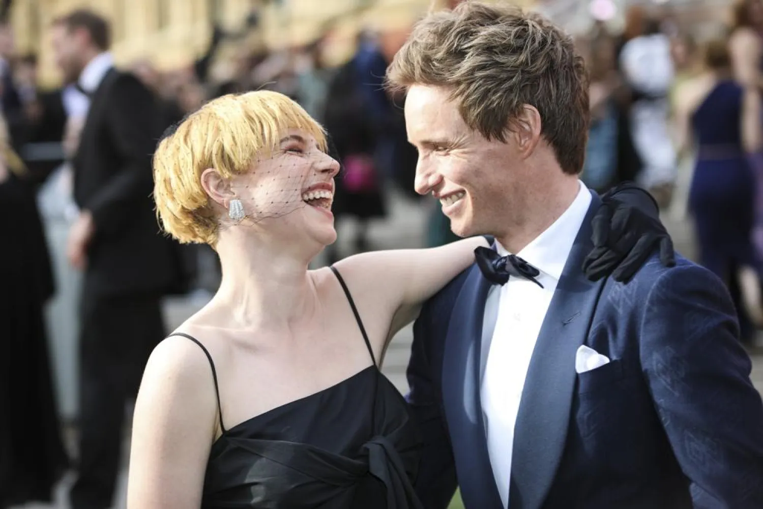 Jessie Buckley, left, and Eddie Redmayne pose for photographers upon arrival at the Olivier Awards in London, Sunday, April 10, 2022. (AP)