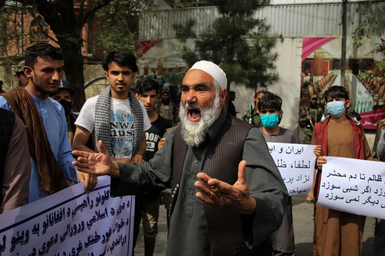 Afghans hold placards and shout slogans during a protest against Iran in Kabul , Afghanistan, 11 April 2022. (EPA)