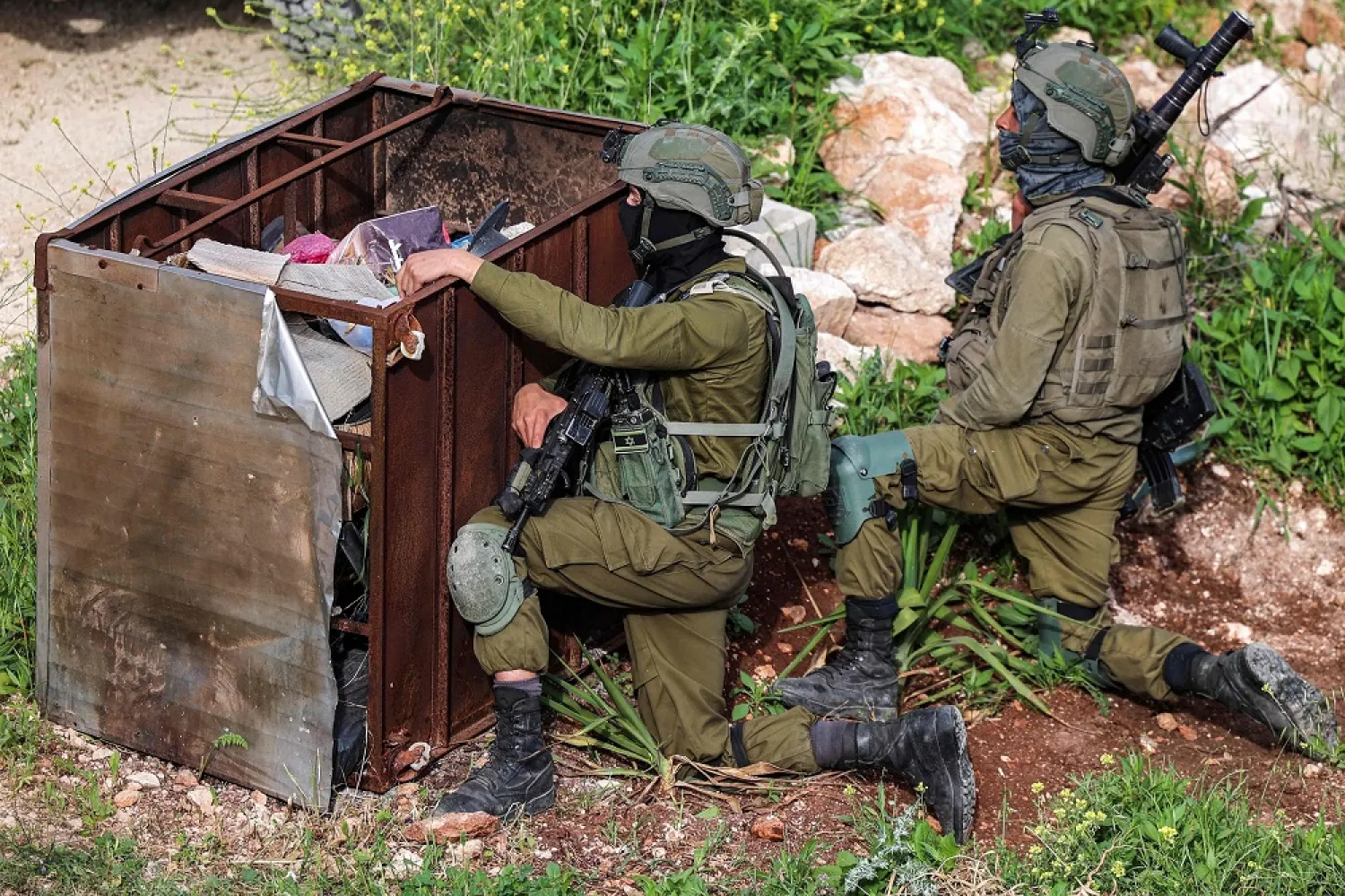 Israeli army soldiers take cover during a military operation in Jenin in the occupied West Bank on April 12, 2022. (AFP)