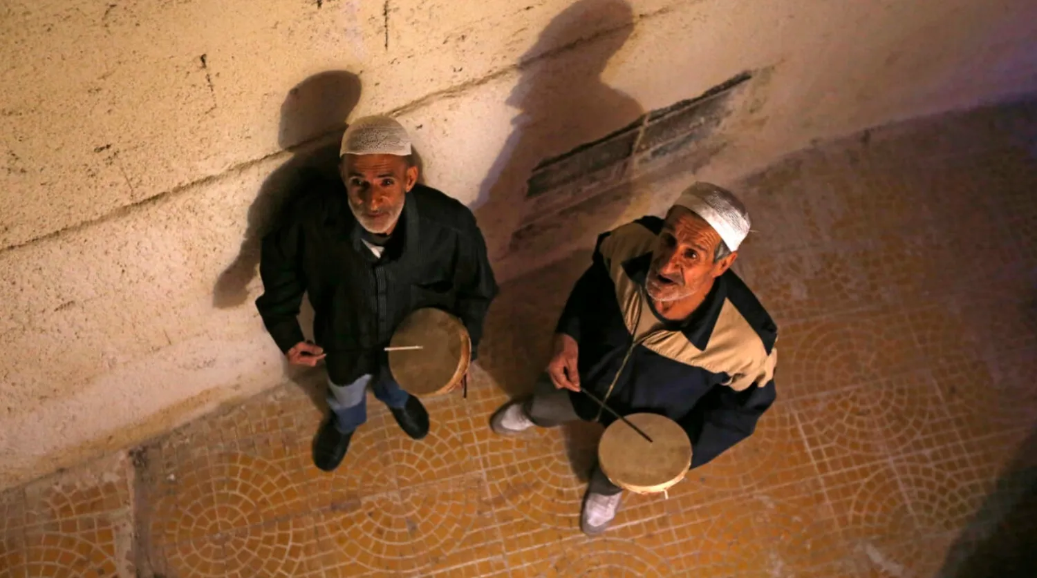 Traditional dawn awakeners known as 'Musaharati' beat drums and chant religious songs to wake up Muslims before sunrise for the 'suhur' meal before the day's fast during the holy month of Ramadan LOUAI BESHARA AFP
