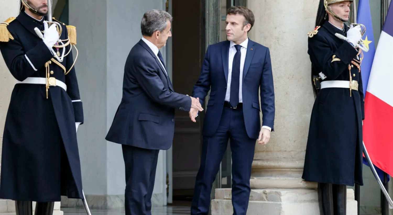 French President Emmanuel Macron (R) shakes hands with French former President Nicolas Sarkozy (L) after a meeting on Russian attack in Ukraine at the Elysee Palace in Paris on February 25, 2022. AFP - LUDOVIC MARIN
