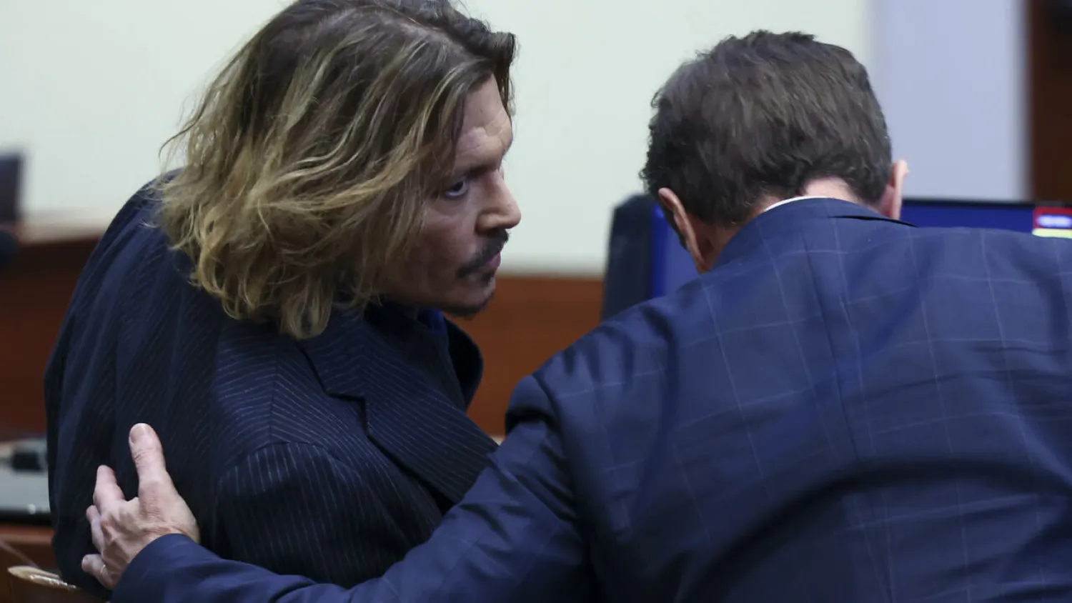 US actor Johnny Depp consulting with his lawyer at his defamation trial against his ex-wife Amber Heard EVELYN HOCKSTEIN POOL/AFP
