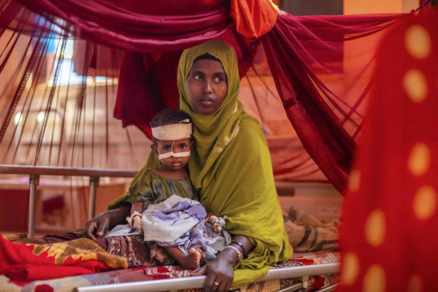 Ethiopia Africa Climate Drought Mother Ayan Muhammed sits with her severely-malnourished baby boy Fahir, as he receives life-saving nutritional treatment, at a UNICEF-supported stabilization center at Gode Hospital in the Shabelle Zone of the Somali region of Ethiopia Tuesday, April 12, 2022. (Zerihun Sewunet/UNICEF via AP) (Zerihun Sewunet)

