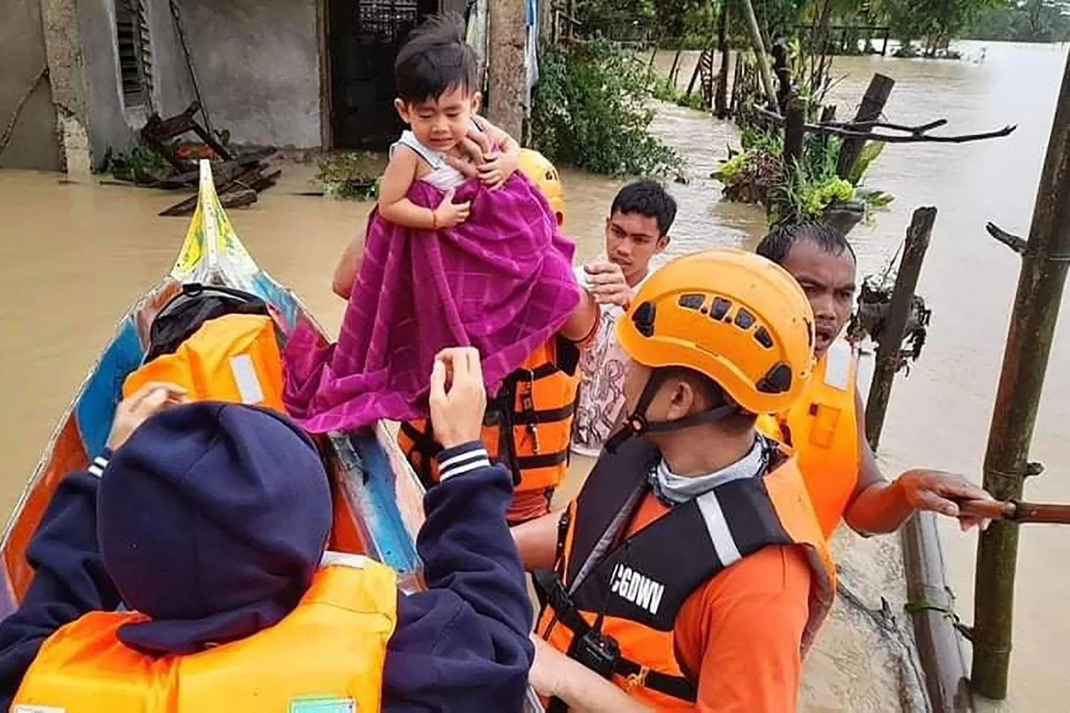 Philippine Coast Guard personnel evacuate local residents from their flooded homes in the town of Panay, Capiz province, on Tuesday, after heavy rains brought on by Tropical Storm Megi inundated the area. PHILIPPINE COAST GUARD / VIA AFP-JIJI
