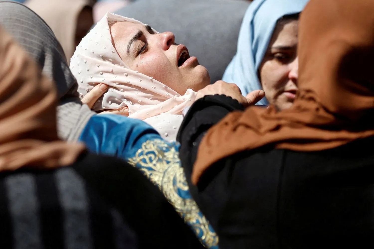 A relative reacts during the funeral of Palestinian Mohammed Assaf, who was killed by Israeli forces during clashes in a raid in the Israeli-occupied West Bank April 13, 2022. REUTERS/Mohamad Torokman