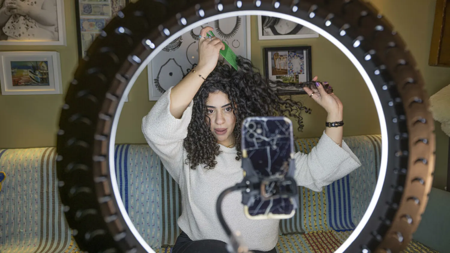 Mariam Ashraf, a teacher and "natural hair influencer", combs her hair during a livestream to her more than 90,000 followers. Khaled DESOUKI AFP
