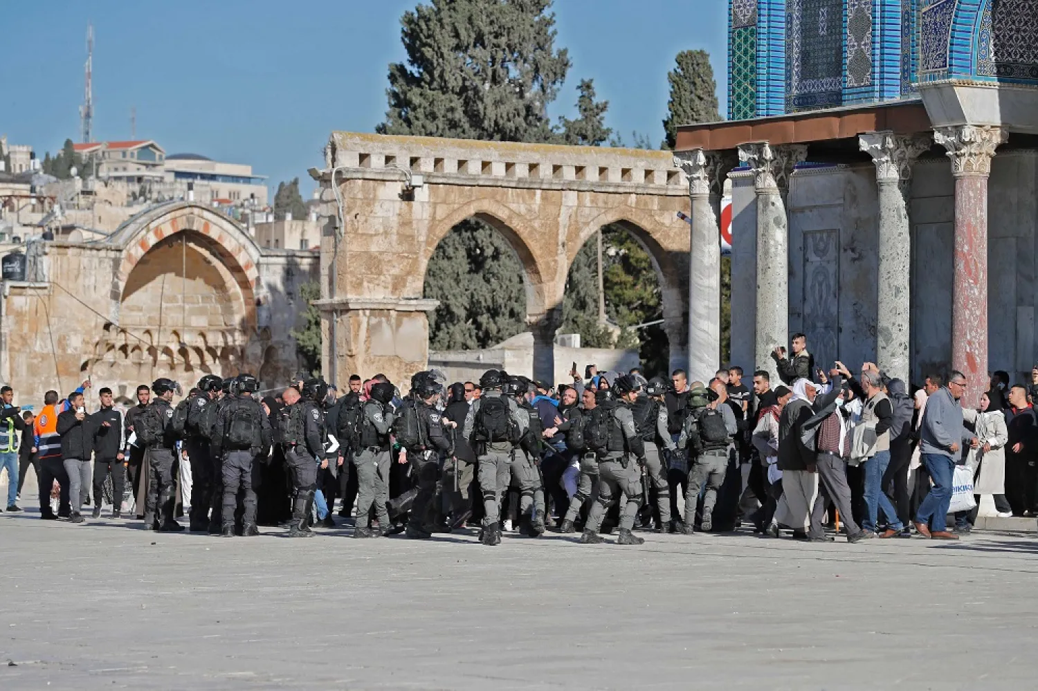 Palestinians are kept at bay by Israeli police during clashes at Jerusalem's Al-Aqsa mosque compound, on April 15, 2022. (AFP)
