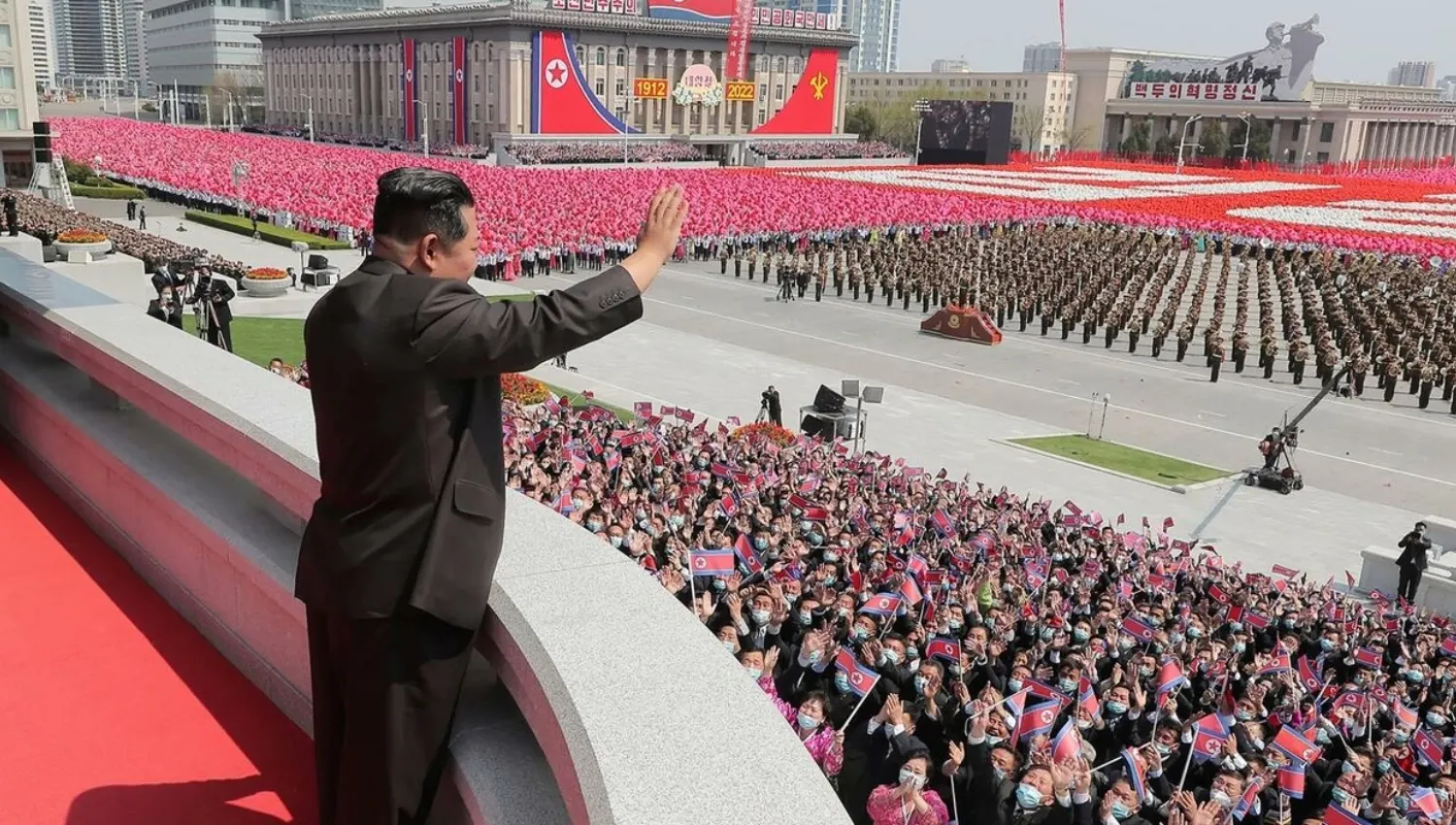 North Korean leader Kim Jong Un waves to crowd gathered in Kim Il Sung Square in Pyongyang, for the 110th anniversary of the late North Korean leader Kim Il Sung's birth, on April 16, 2022. © Korean Central News Agency (KCNA) via KNS, AFP
