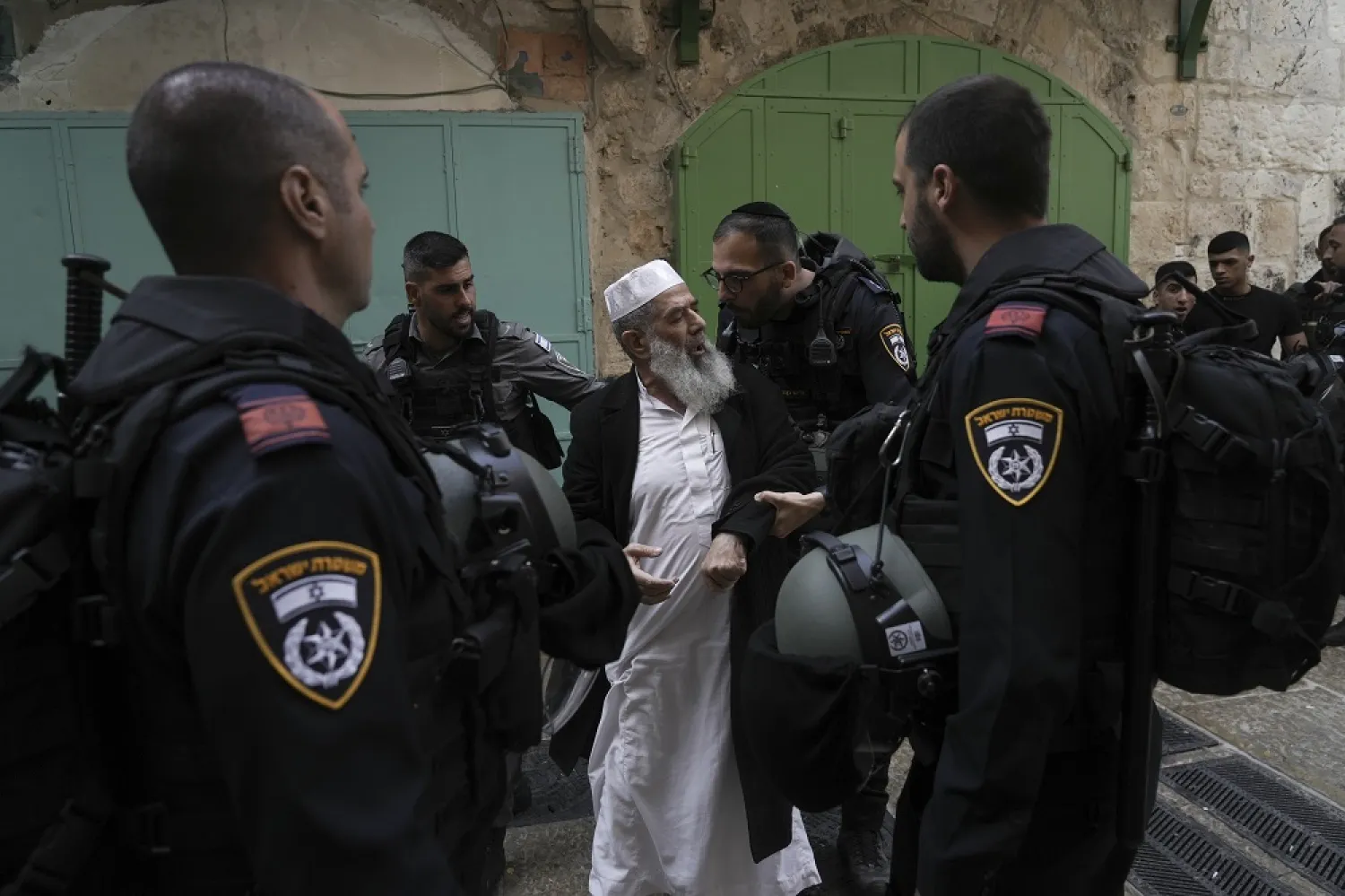 Israel police argue with a Palestinian worshipper in the Old City of Jerusalem, Sunday, April 17, 2022. (AP)