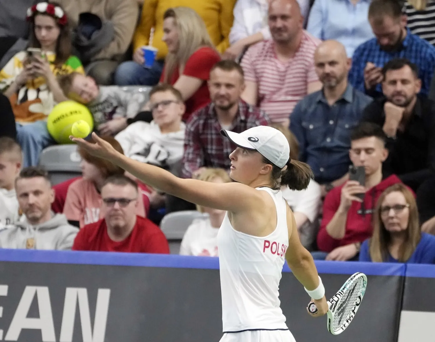 Iga Swiatek, of Poland, gets ready to serve against Mihaela Buzarnescu, of Romania, during a singles match of the qualifying round of the Billie Jean King Cup in Radom, Poland, Friday, April 15, 2022. (AP)