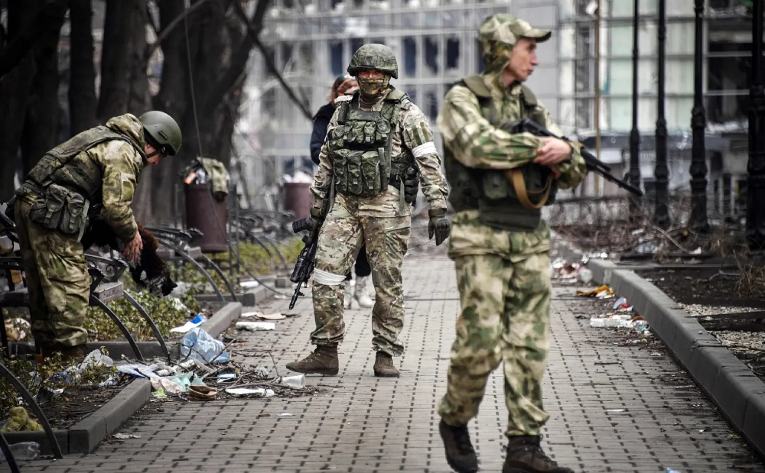 Russian soldiers walk along a street in Mariupol on April 12, 2022. (AFP)