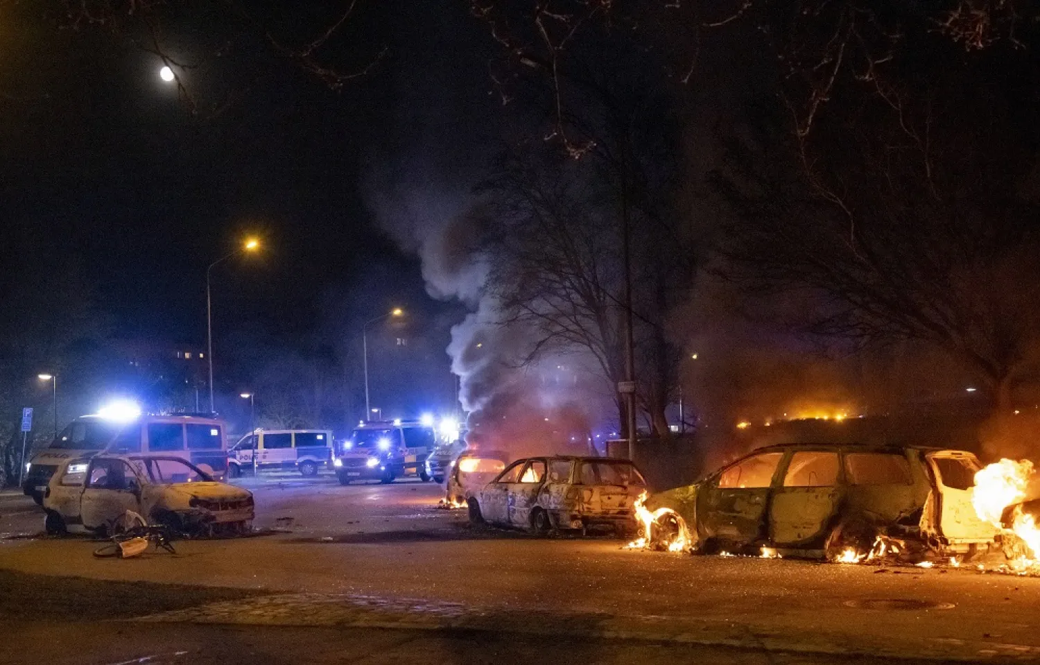 Police on the scene and cars on fire on Von Rosens vag near Rosengardsskolan during a protest at Rosengard in Malmo, Sweden, late 17 April 2022. (EPA)