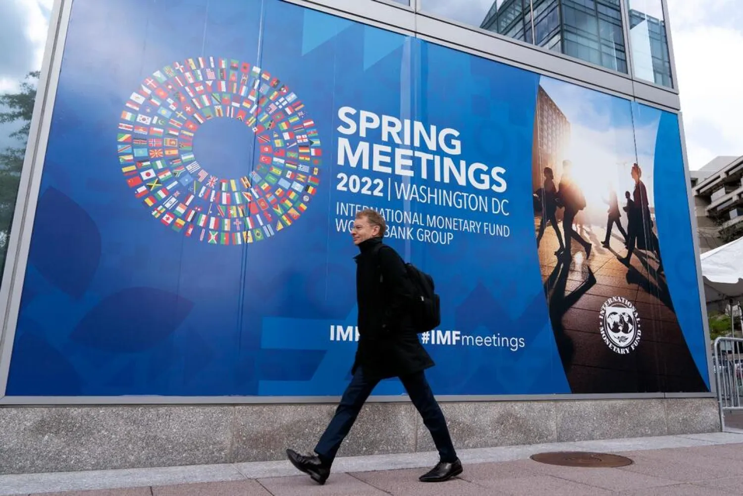 A person walks outside of the International Monetary Fund (IMF) building, during the first day of the World Bank/IMF Spring meetings in Washington, Tuesday, April 19, 2022. (AP)