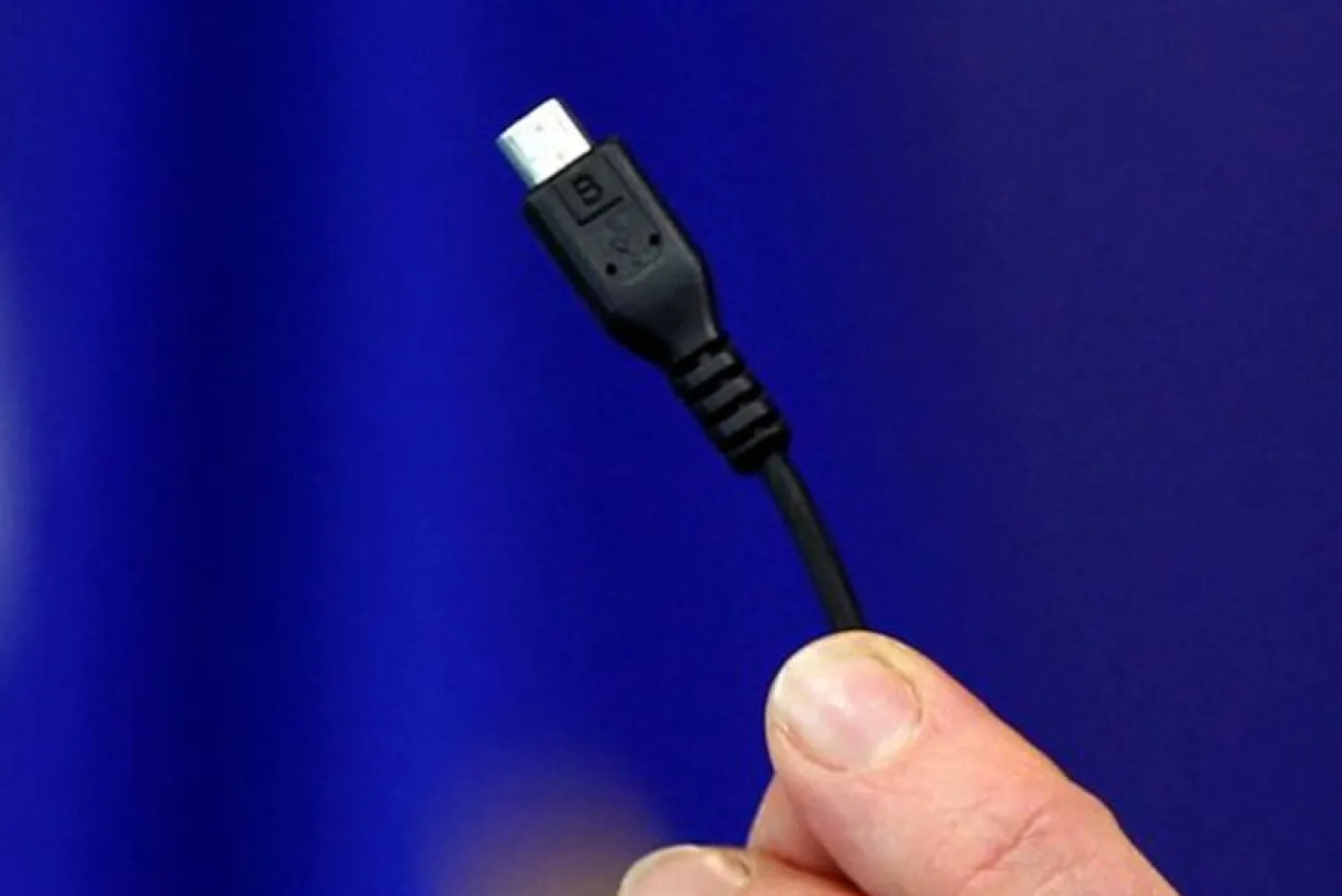 Bridget Cosgrave, Director General of DigitalEurope, displays a harmonized mobile phone charger during a news conference at the European Commission headquarters in Brussels February 8, 2011. (Reuters)