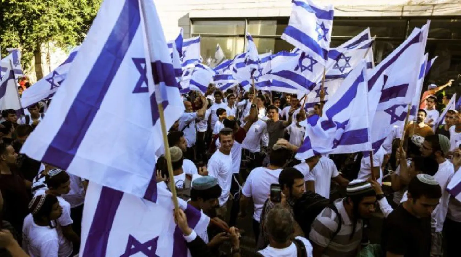 Israelis wave Israeli flags outside Jerusalem's Old City, June 15,2021. (File/Reuters)
