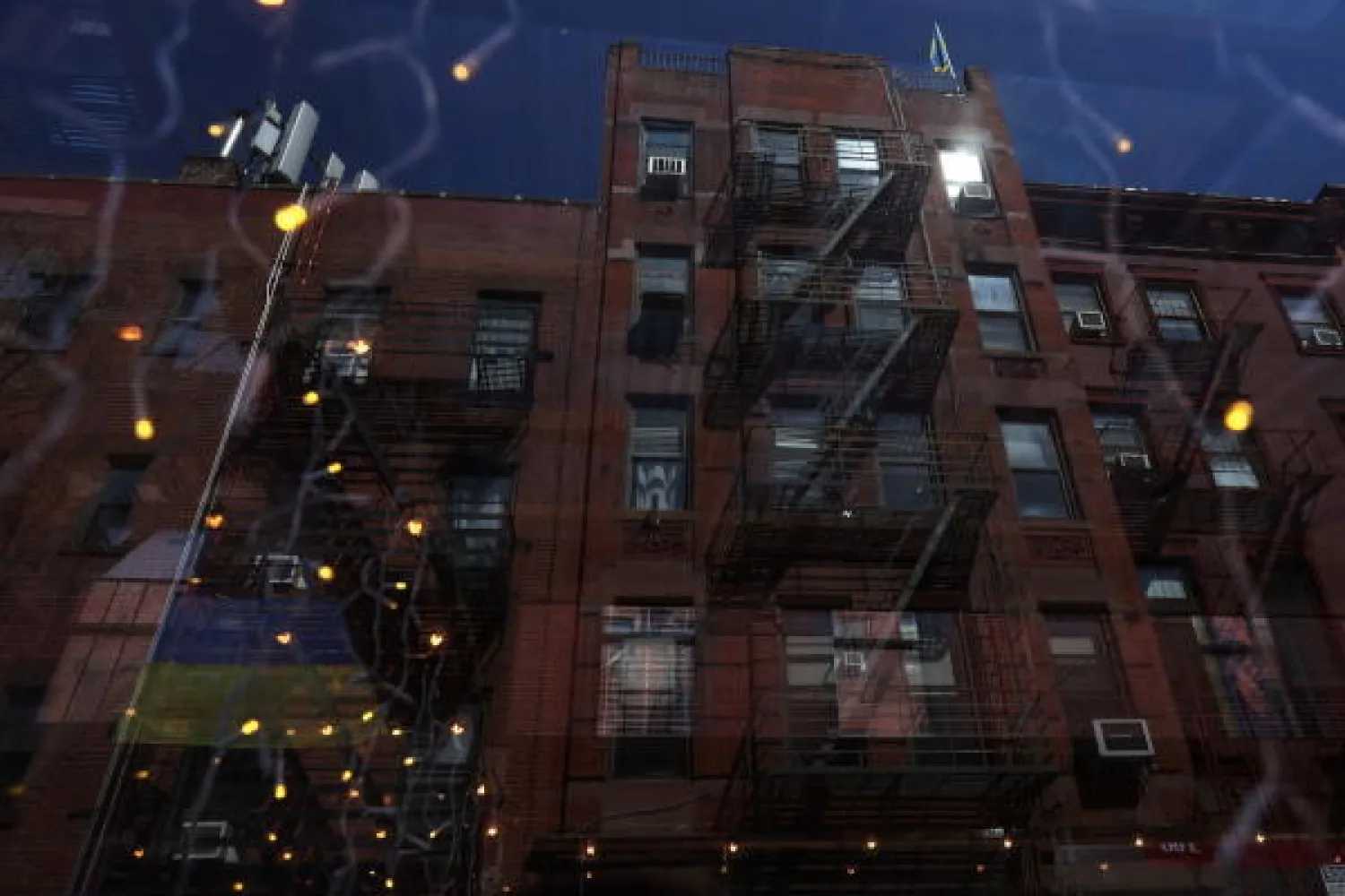 Flags of Ukraine hang from the fire escapes of a building, amid Russia's invasion of Ukraine, on the Lower East Side of New York City, US, April 20, 2022. REUTERS/Shannon Stapleton
