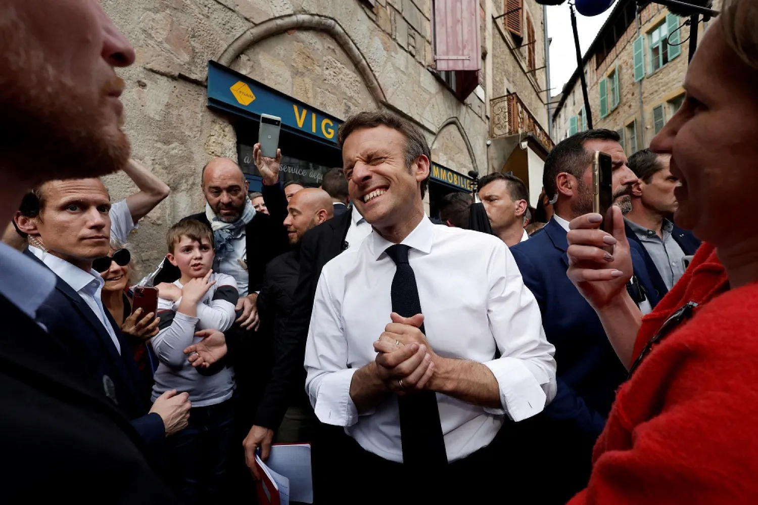 French President Emmanuel Macron, candidate for his re-election in the 2022 French presidential election, reacts as he meets with supporters after a campaign rally in Figeac on the last day of campaigning, ahead of the second round of the presidential election, France, April 22, 2022. (Reuters)