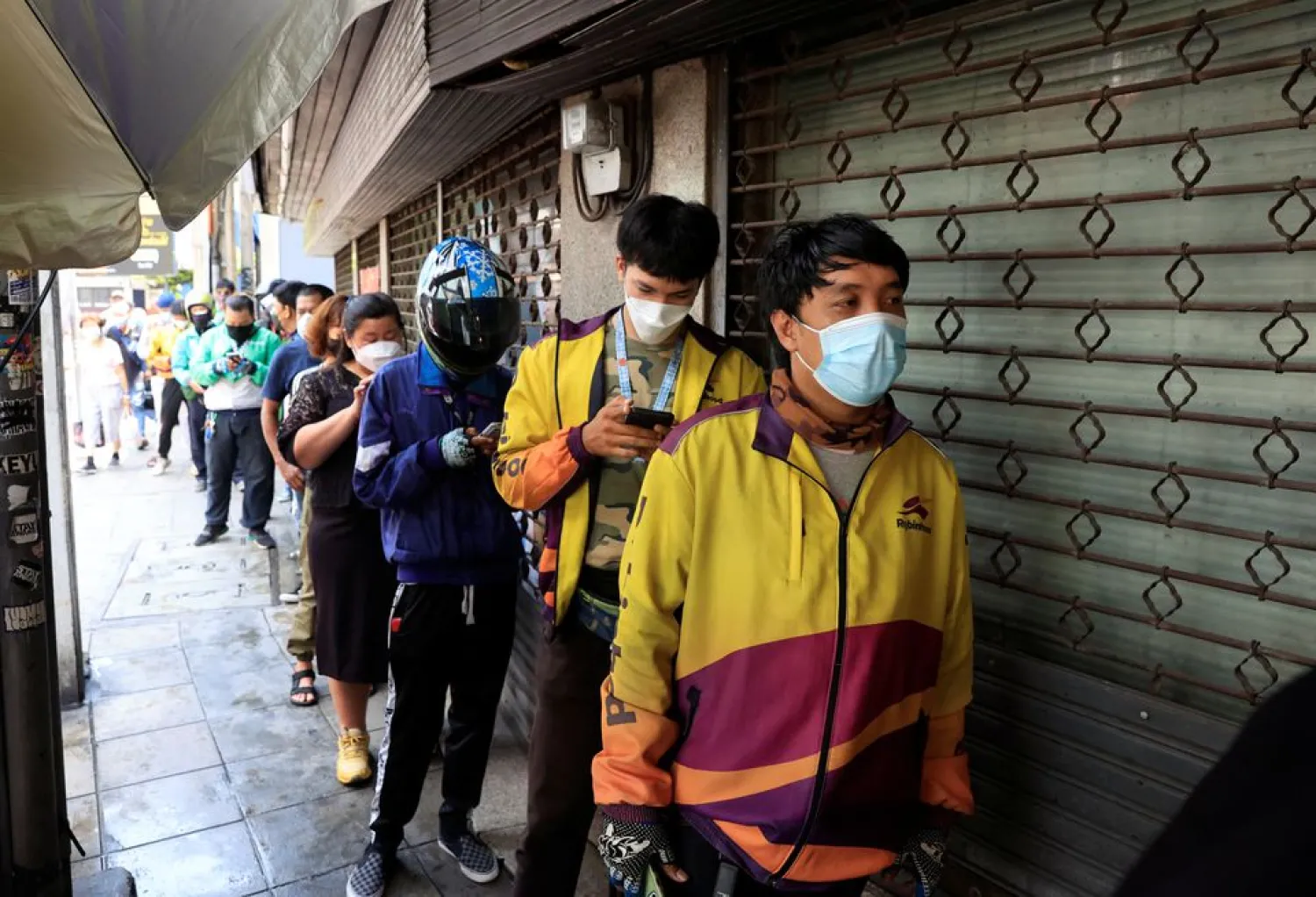 Delivery bikers line up at a Mango sticky rice shop in Bangkok April 21, 2022. (Reuters)