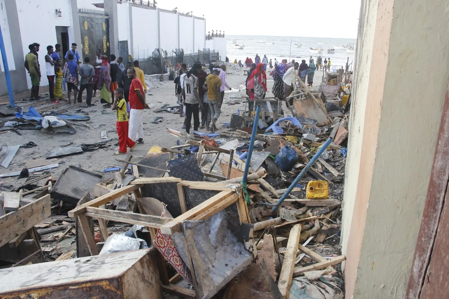 People look at destroyed shops in Mogadishu's Lido beach, Somalia, Saturday, April, 23, 2022, after a bomb blast by Somalia’s extremist rebels hit a popular seaside restaurant killing at least six people. (AP)