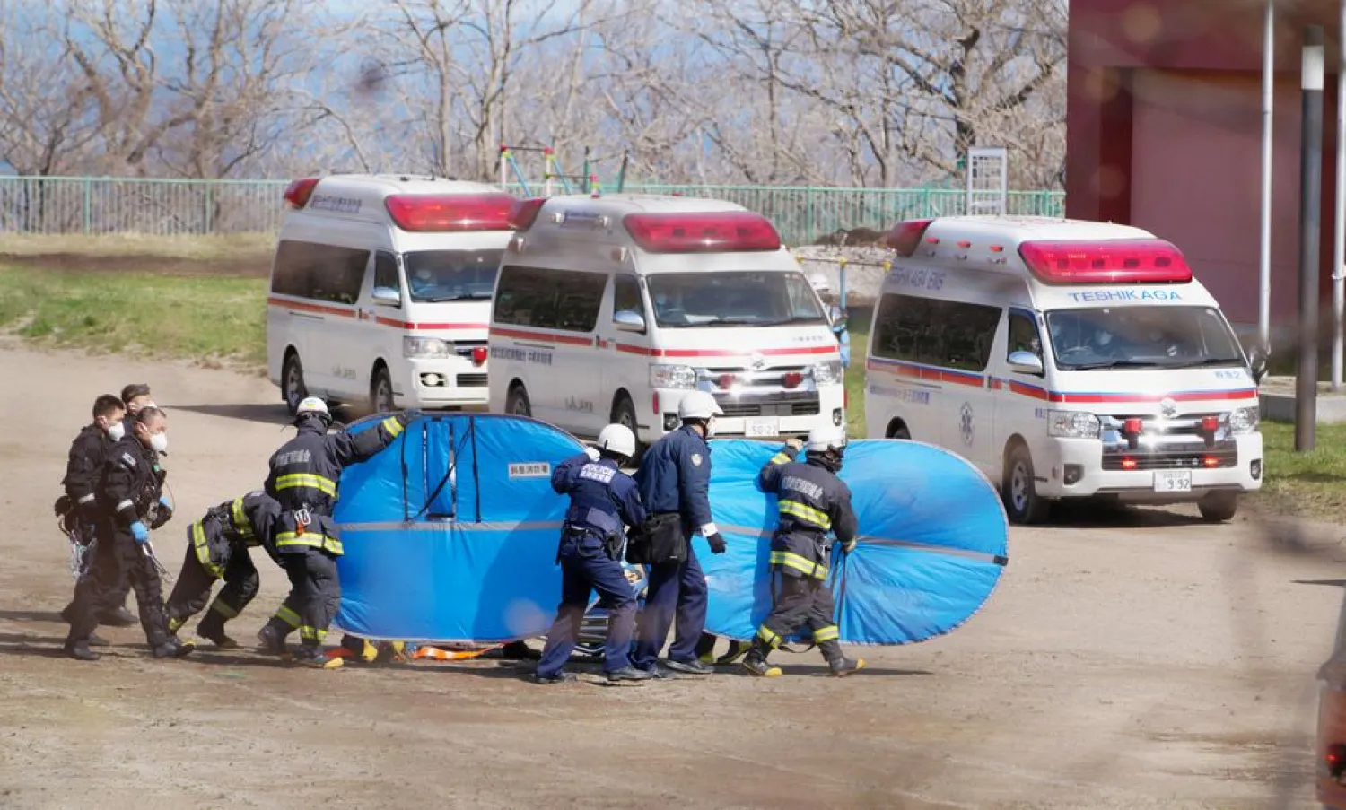 Firefighters and police officers transport rescued people from the missing tour boat "Kazu 1" from Japanese Self-Defense Force's helicopters in Shari, Hokkaido Prefecture, Japan in this photo taken by Kyodo on April 24, 2022. Mandatory credit Kyodo/via REUTERS