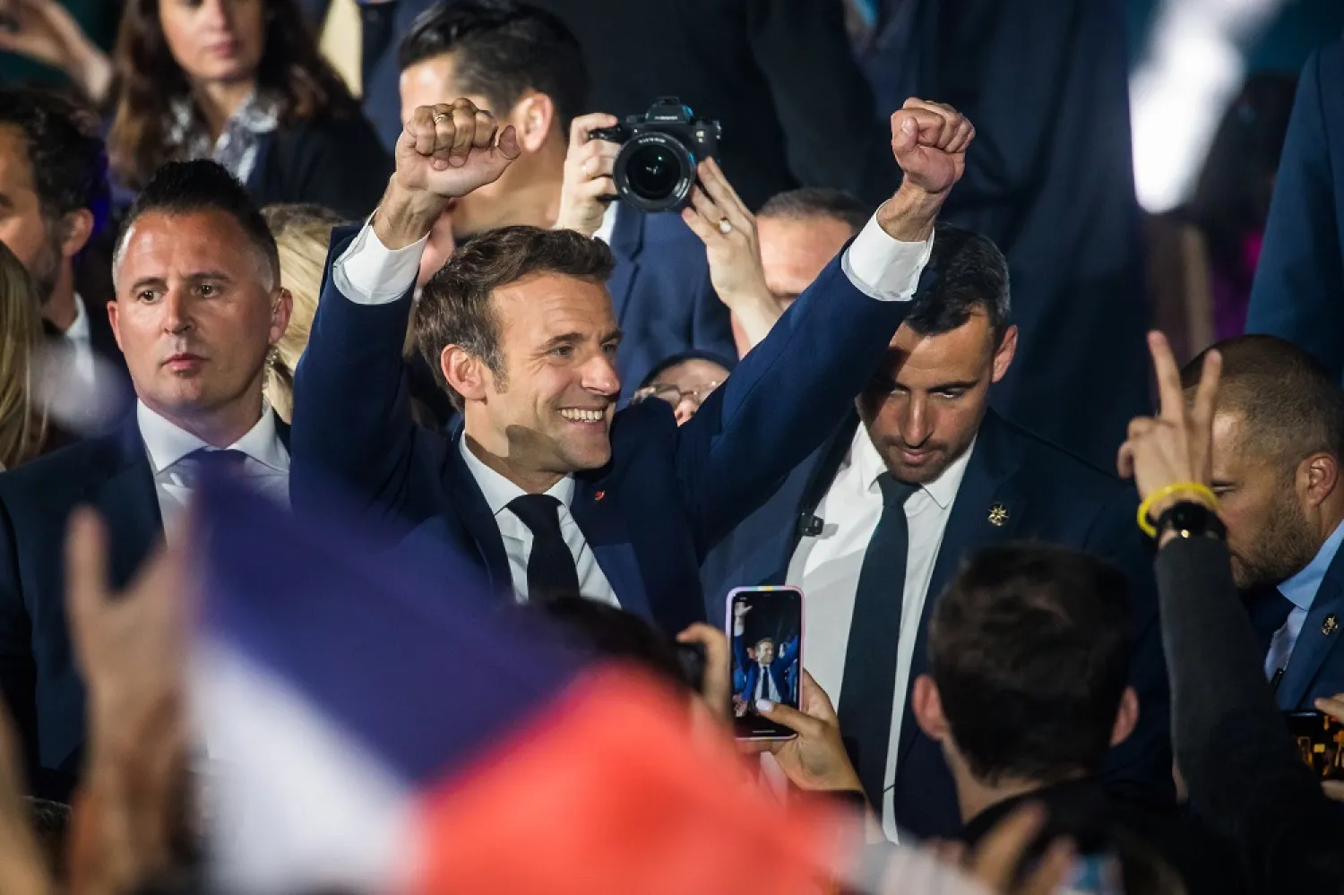 French President Emmanuel Macron reacts with supporters after winning the second round of the French presidential elections at the Champs-de-Mars after Emmanuel Macron won the second round of the French presidential elections in Paris, France, 24 April 2022 (issued 25 April 2022). (EPA)
