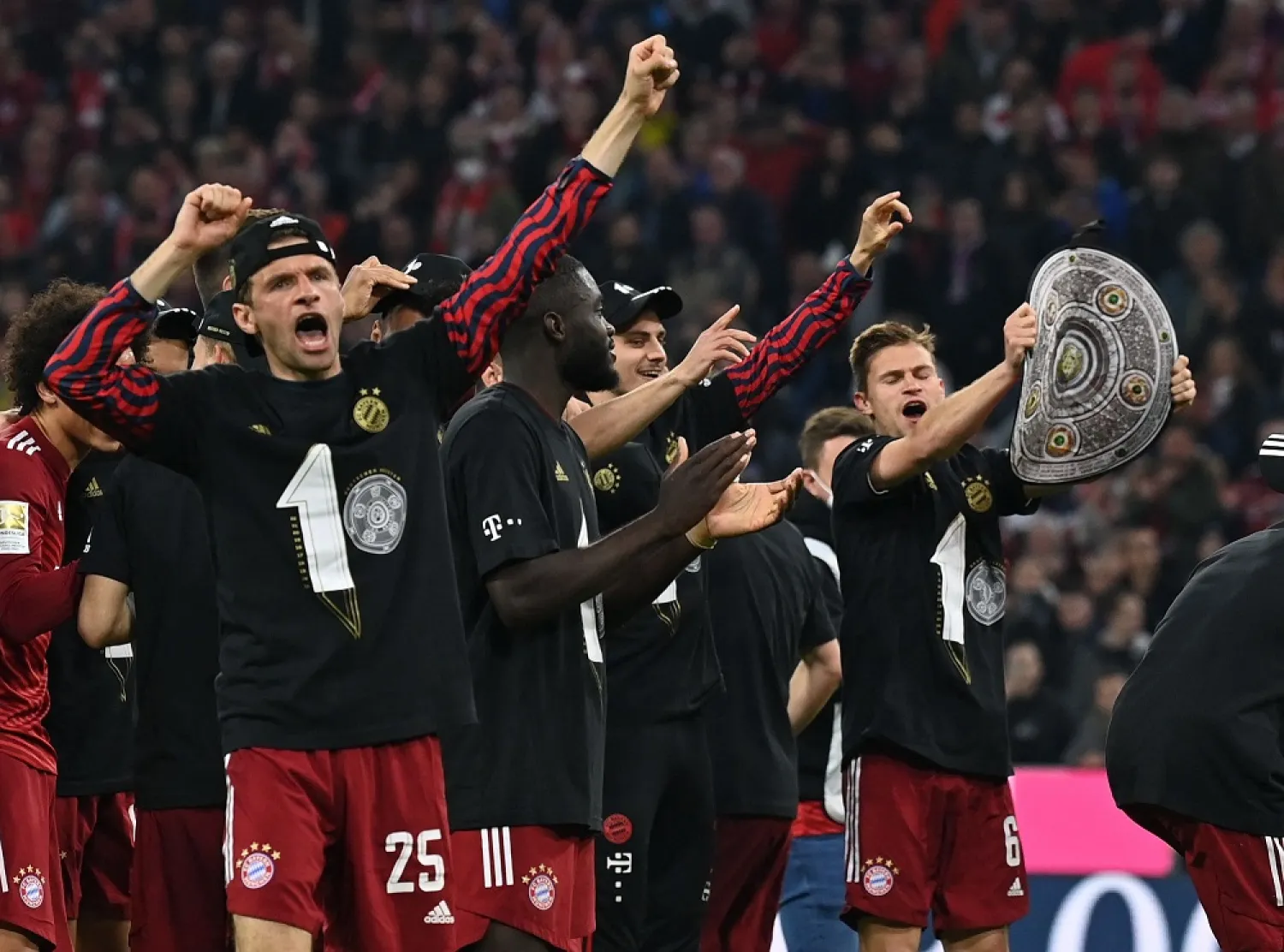 Bayern Munich players including Bayern Munich's German forward Thomas Mueller (L) celebrate after the German first division Bundesliga football match FC Bayern Munich v BVB Borussia Dortmund in Munich, southern Germany on April 23, 2022. (AFP)
