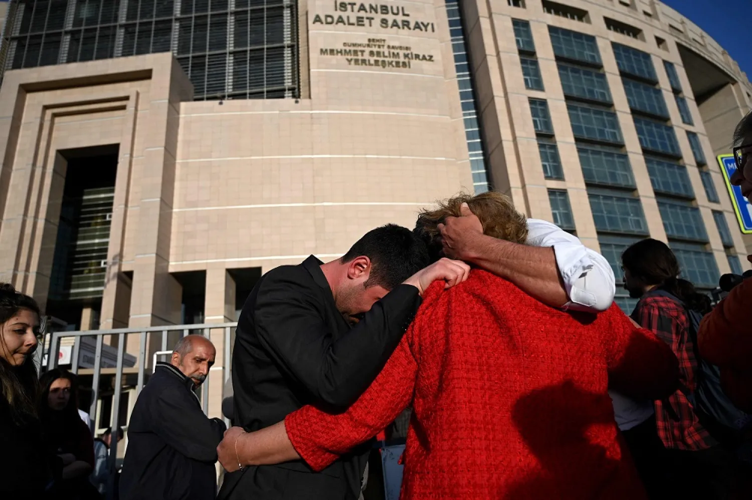 Demonstrators including lawyers and opposition lawmakers react after the verdict of jailed rights defender Osman Kavala outside Istanbul courthouse, on April 25, 2022. (AFP)