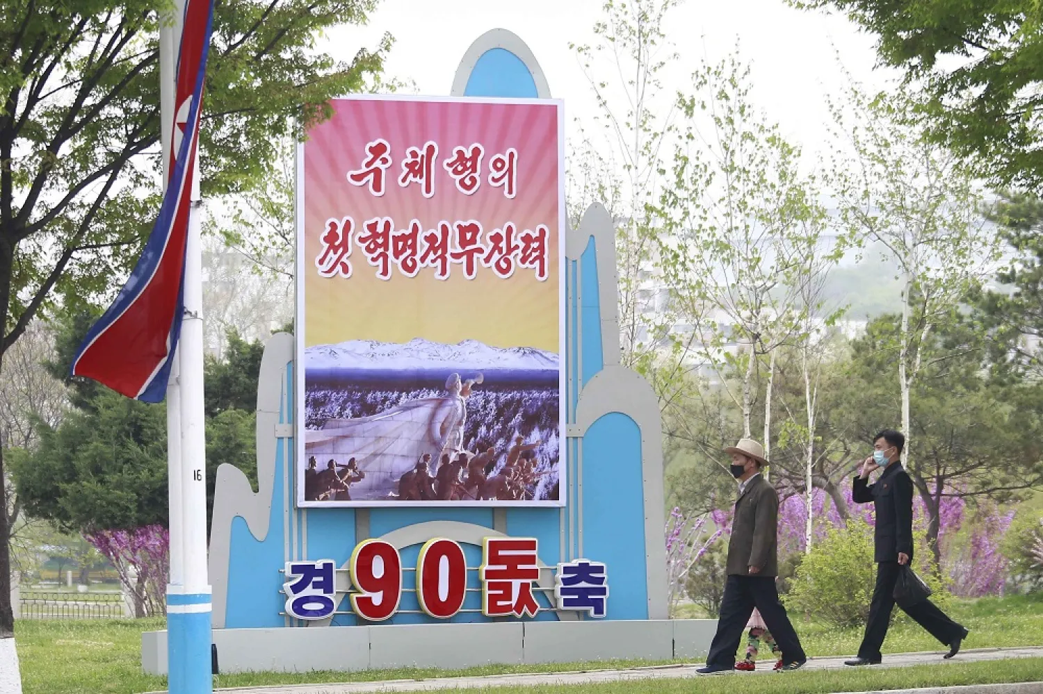 Citizens walk past a celebrative poster displayed on the occasion of 90th founding anniversary of Korean People's Revolutionary Army in Pyongyang, North Korea, Monday, April 25, 2022. Poster reads "The first Juche oriented armed force". (AP)