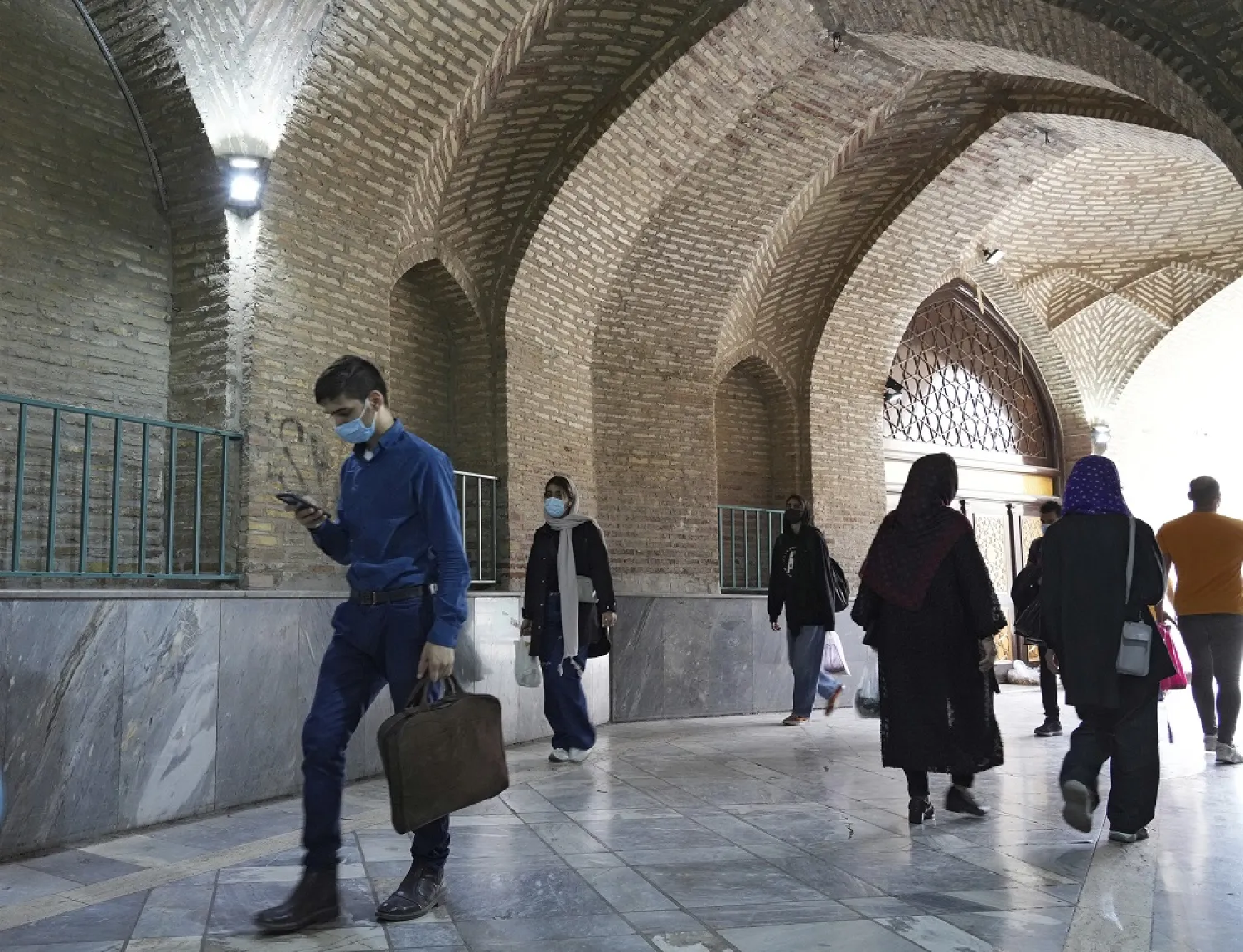People walk through a corridor of Imam Mosque in the Grand Bazaar of Tehran, Iran, Saturday, April 16, 2022. (AP)