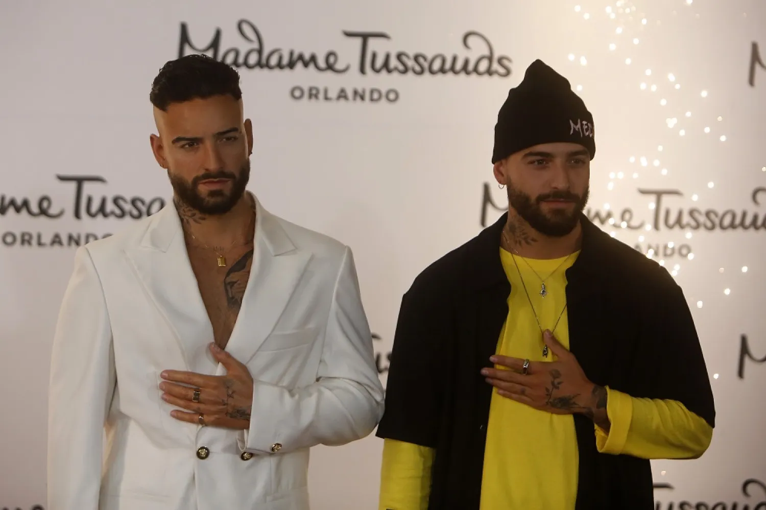 Colombian singer Maluma reacts to seeing his Madame Tussauds wax figure during the unveiling in Medellín, Colombia, 25 April 2022. (EPA)