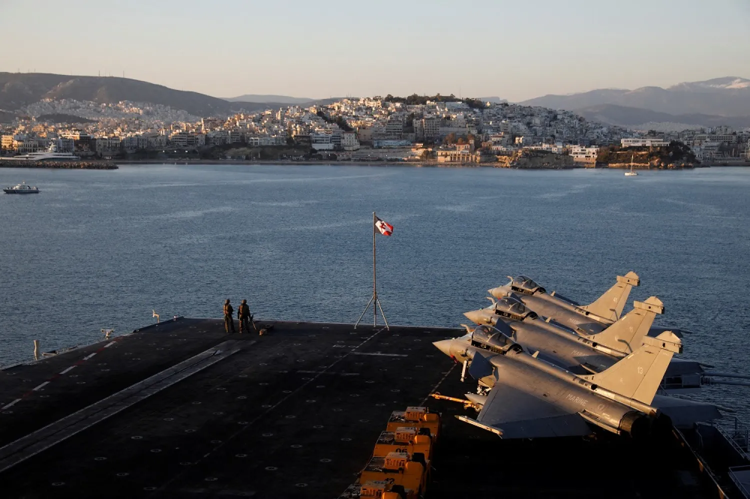 French Navy Rafale fighter jets stand parked onboard the Charles de Gaulle aircraft carrier, off the shore of the Faliro suburb, in Athens, Greece, March 24, 2022. (Reuters)
