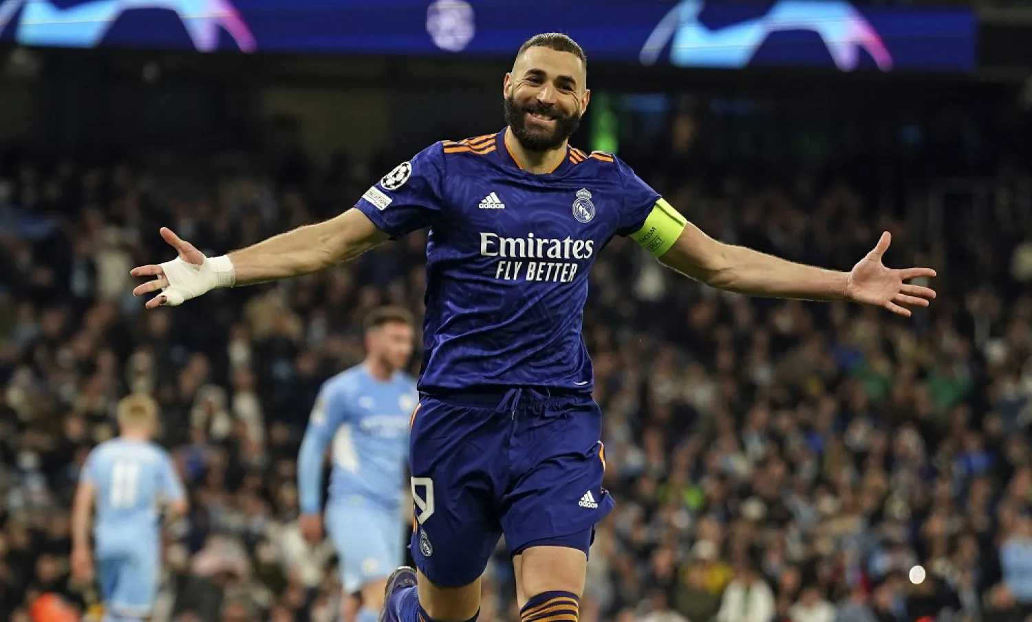 Real Madrid's Karim Benzema celebrates after scoring his side's third goal from penalty during the Champions League semi final, first leg soccer match between Manchester City and Real Madrid at the Etihad stadium in Manchester, England, Tuesday, April 26, 2022. (AP)