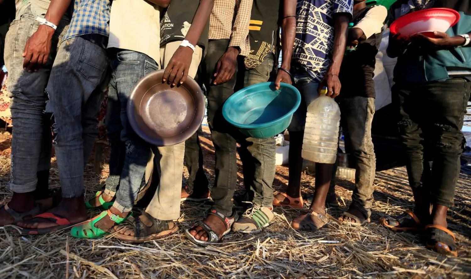 Ethiopian refugees who fled Tigray region, queue to receive food aid within the Um-Rakoba camp in Al-Qadarif state, on the border, in Sudan December 11, 2020. REUTERS/Mohamed Nureldin Abdallah/File Photo