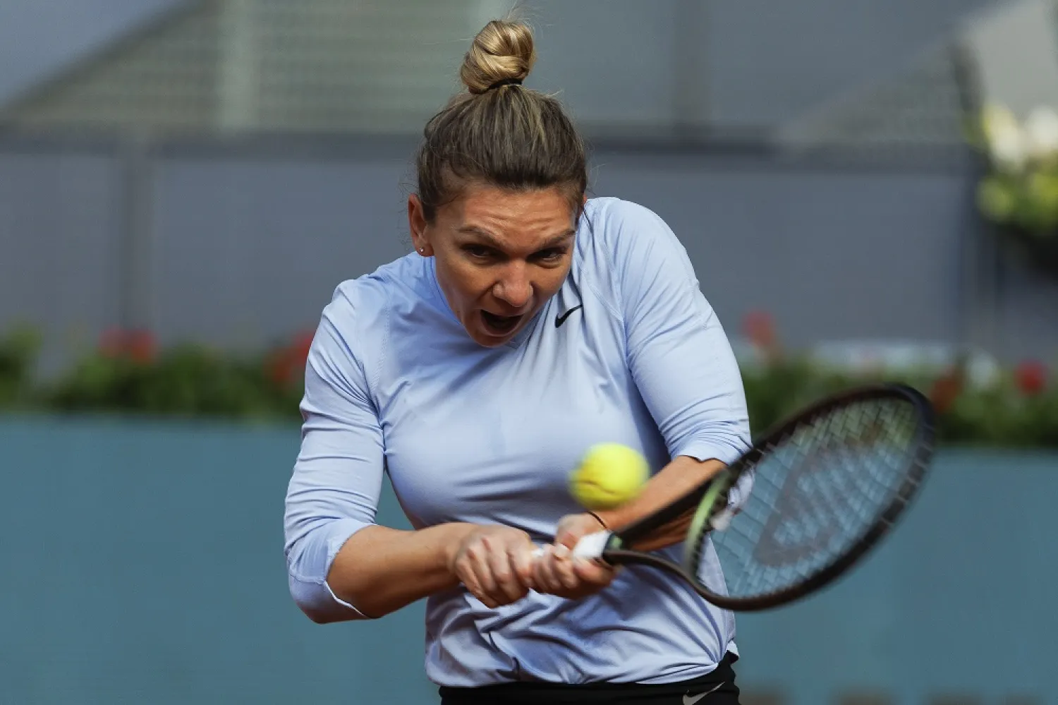 Simona Halep of Romania performs during a training session at Manolo Santana court ahead of her participation in the Mutua Madrid Open tennis tournament in Madrid, Spain, 26 April 2022. (EPA)
