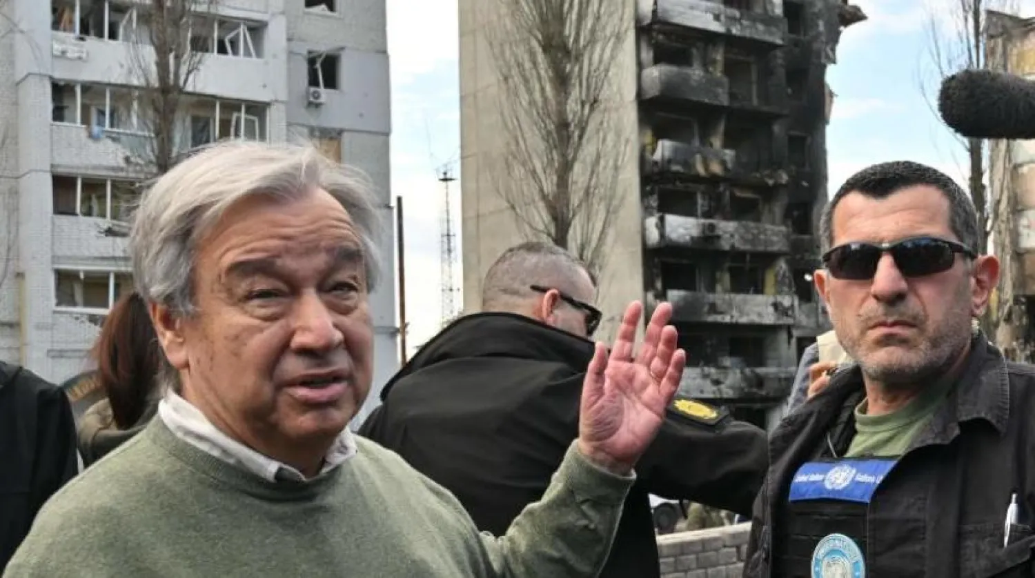 UN Secretary-General Antonio Guterres (L) gestures as he walks during his visit in Borodianka, outside Kyiv, on April 28, 2022. (Photo by Sergei SUPINSKY / AFP)
