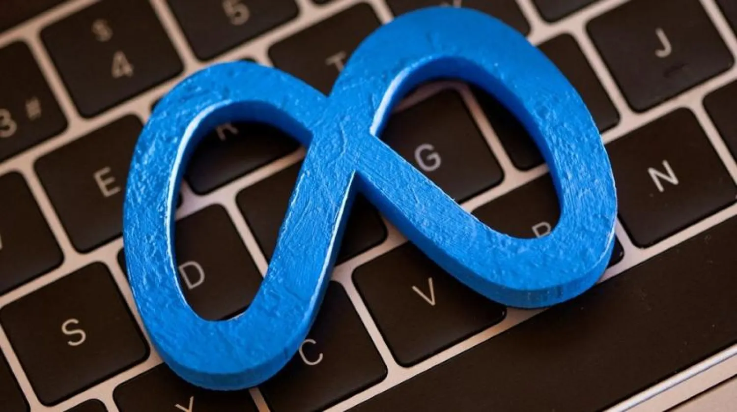 A 3D printed Facebook's new rebrand logo Meta is placed on laptop keyboard in this illustration taken on November 2, 2021. (Reuters)
