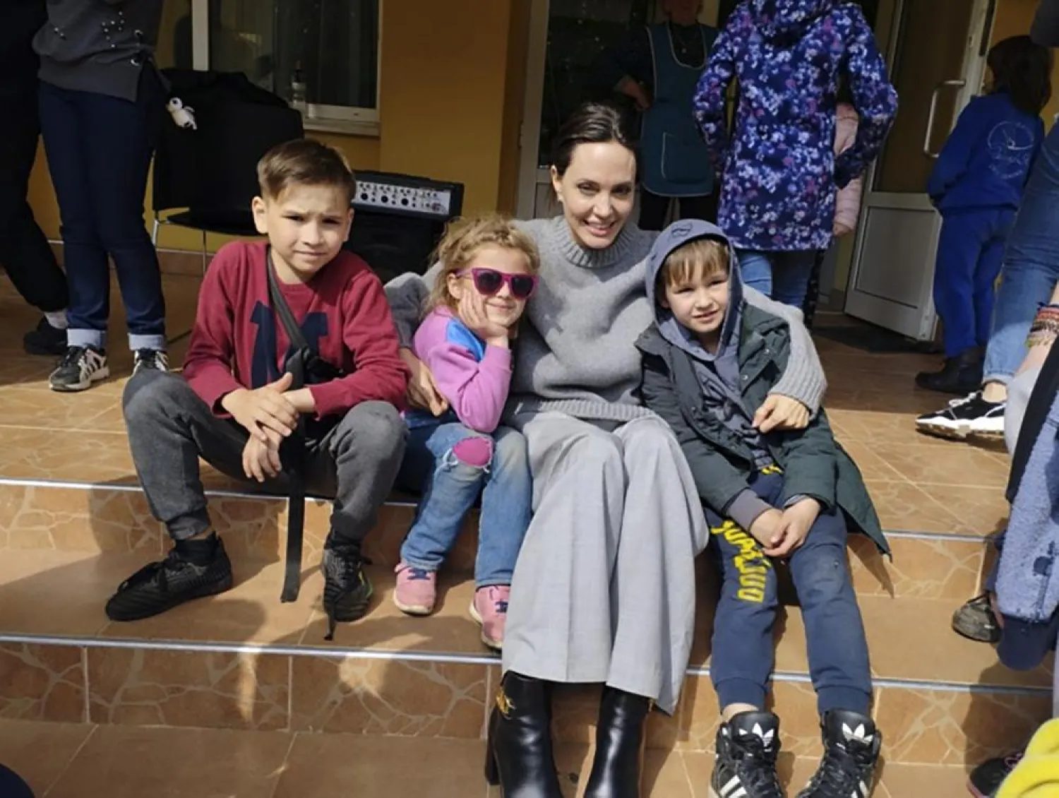 In this image provided by the Lviv city hall Angelina Jolie, Hollywood movie star and UNHCR goodwill ambassador, poses for photo with kids in Lviv, Ukraine, Saturday, Apr. 30, 2022. (Lviv City Hall via AP)