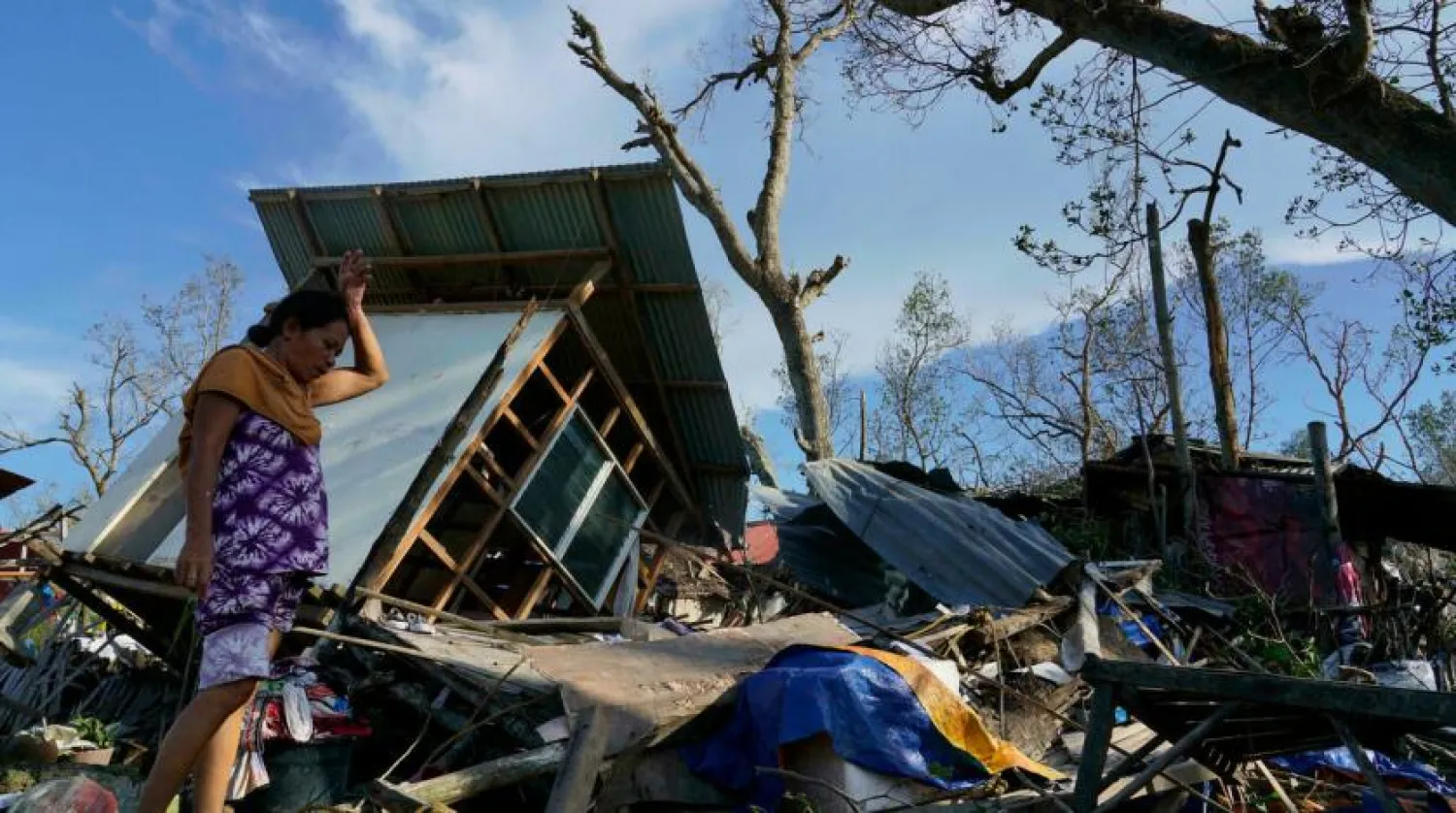 A resident salvages parts of her home damaged by Typhoon Rai in Talisay, central Philippines on December 18, 2021. Jay Labra, AP
