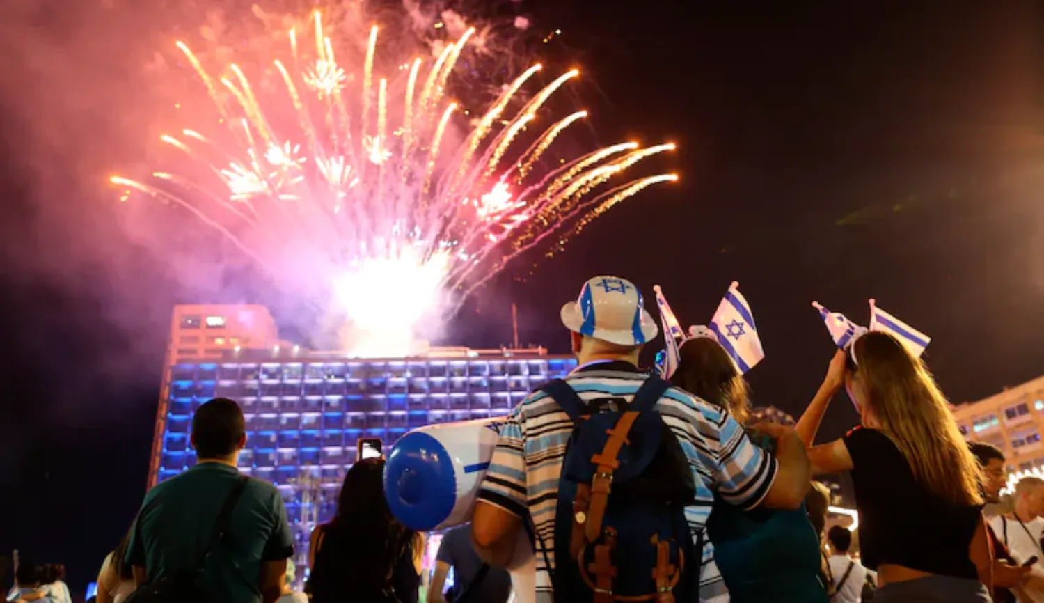 FILE - Israelis watch a fireworks display during the celebrations for Israel’s 70th Independence Day, at Rabin square in Tel Aviv, Israel, Wednesday, April 18, 2018. (AP Photo/Oded Balilty, File)
