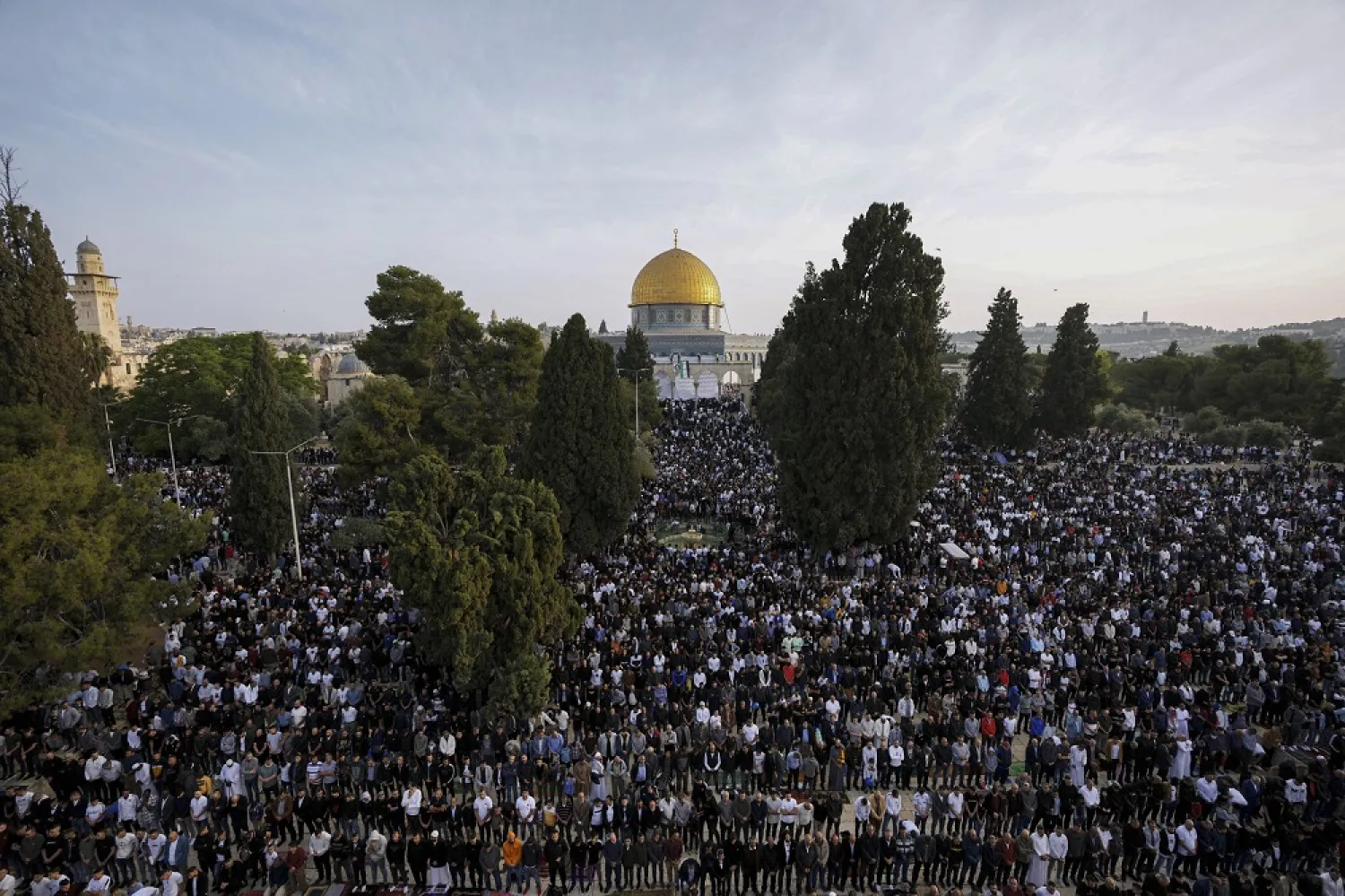 Muslims take part in Eid al-Fitr prayers next to the Dome of the Rock Mosque in the Al-Aqsa Mosque compound atop the Temple Mount in the Old City of Jerusalem, Monday, May 2, 2022. (AP)