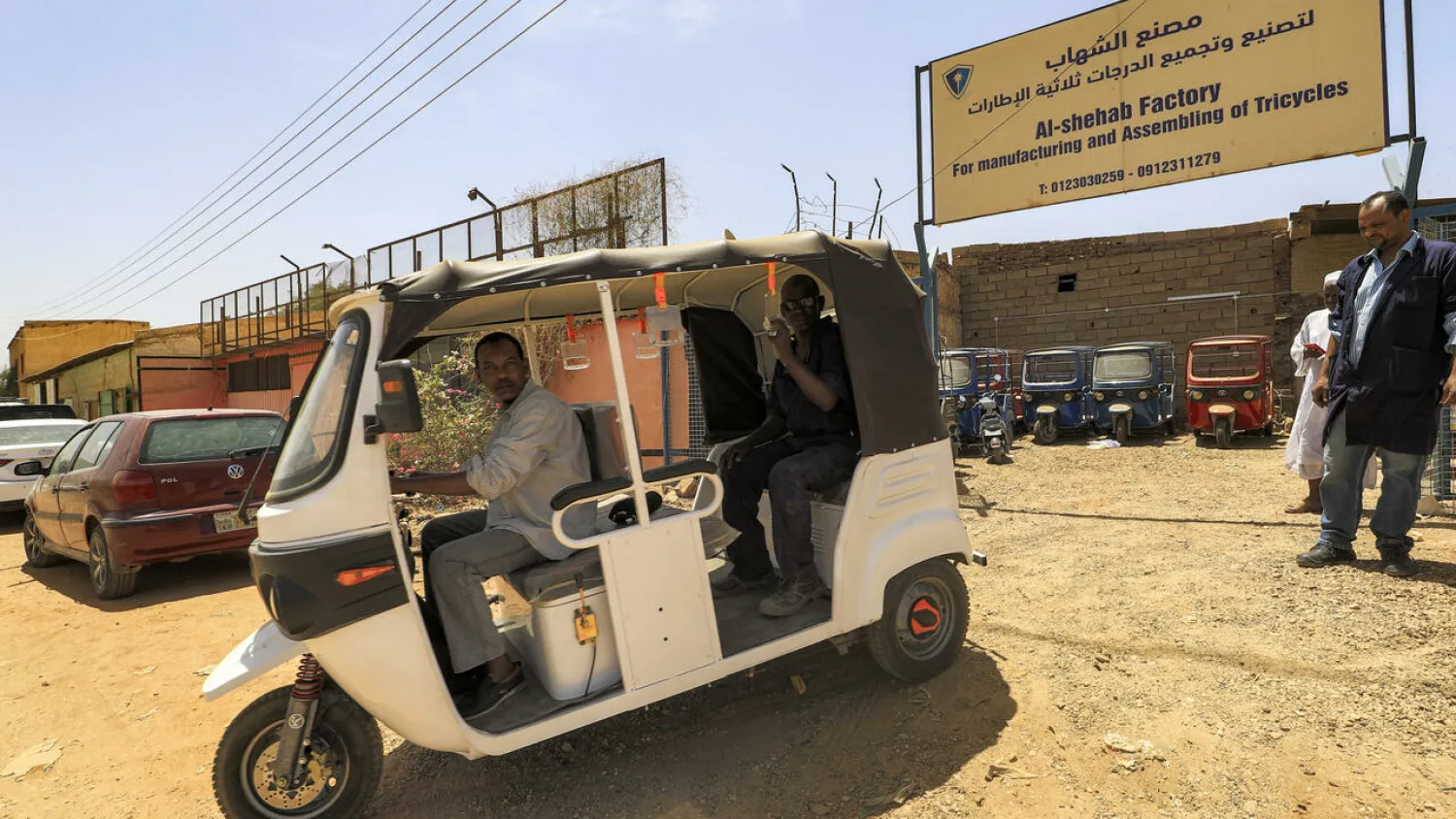 Sudanse workers test a new electric tuk-tuk ASHRAF SHAZLY AFP
