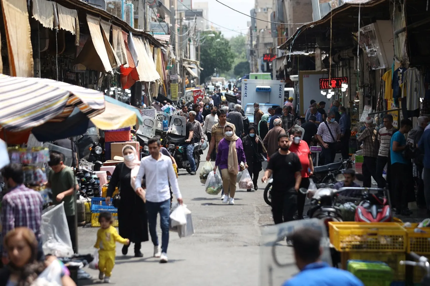 Iranians walk in a market in Tehran, Iran May 1, 2022. (West Asia News Agency via Reuters)