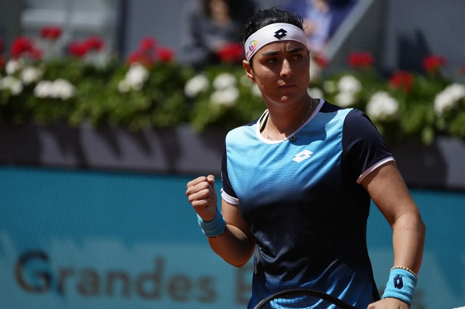 Ons Jabeur of Tunisia gestures after a winning point against Simona Halep of Romania during their match at the Mutua Madrid Open tennis tournament in Madrid, Spain, Wednesday, May 4, 2022. (AP)