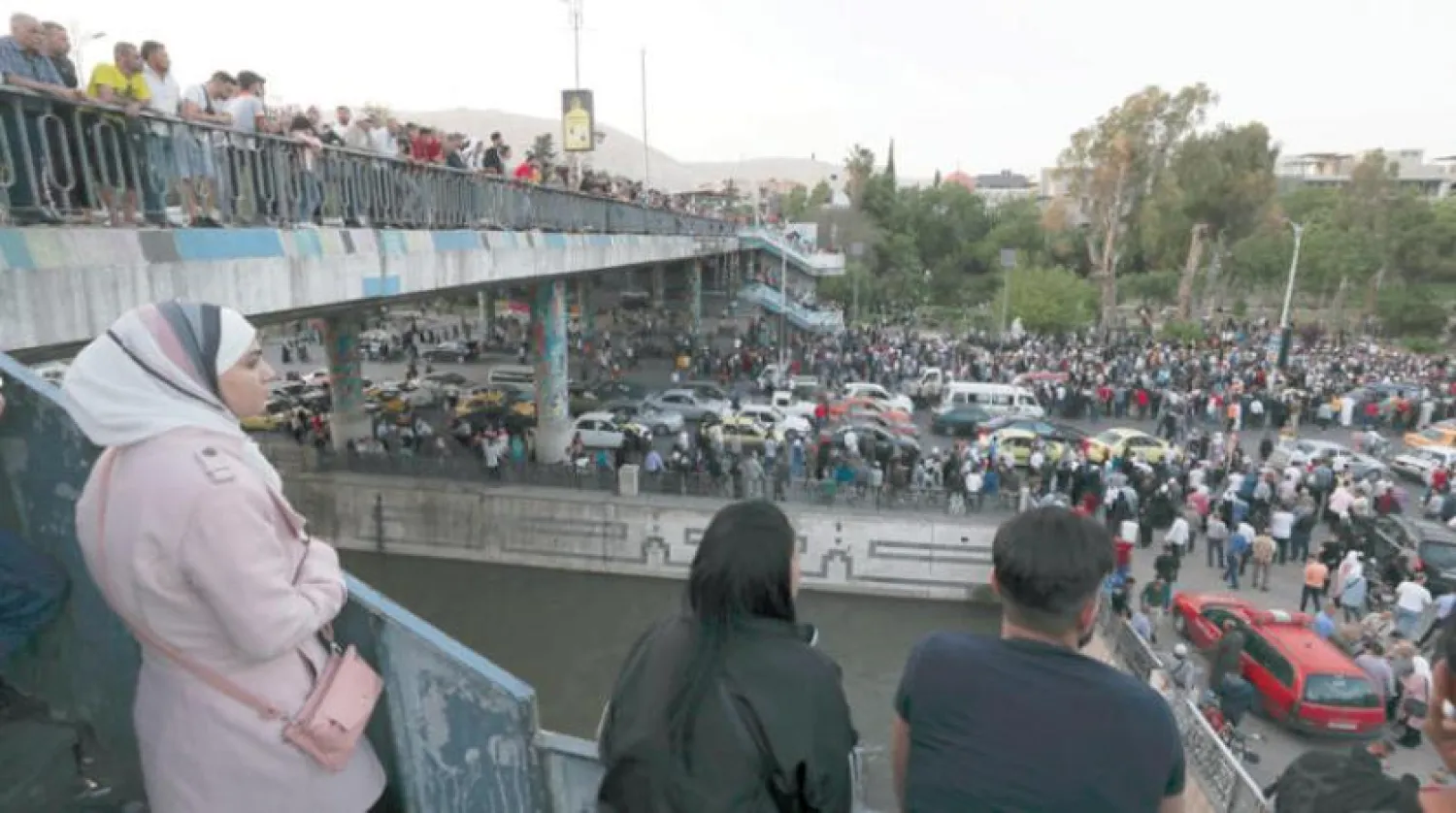 Syrians wait at the President's Bridge in Damascus for relatives they hope would be among those released from prison on Tuesday, May 3, 2022, on the second day of the Fitr holiday. (AP Photo/Omar Sanadiki)