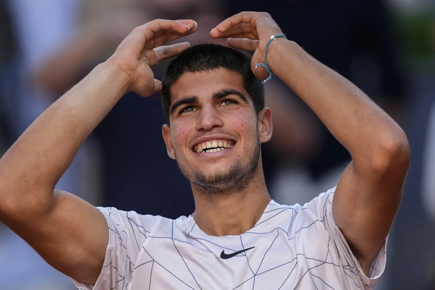 Spain's Carlos Alcaraz celebrates after winning a match against Spain's Rafael Nadal at the Mutua Madrid Open tennis tournament in Madrid, Friday, May 6, 2022. (AP)