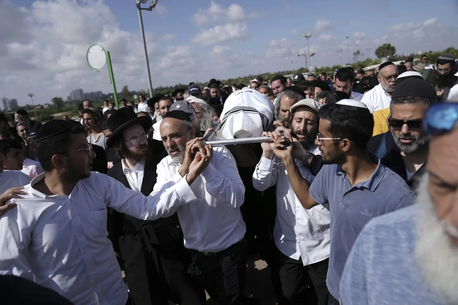 Mourners carry Yonatan Havakuk to his burial in Petah Tikva, Israel, the day after he was killed with two others in a stabbing attack in Elad, Friday, May 6, 2022. (AP)