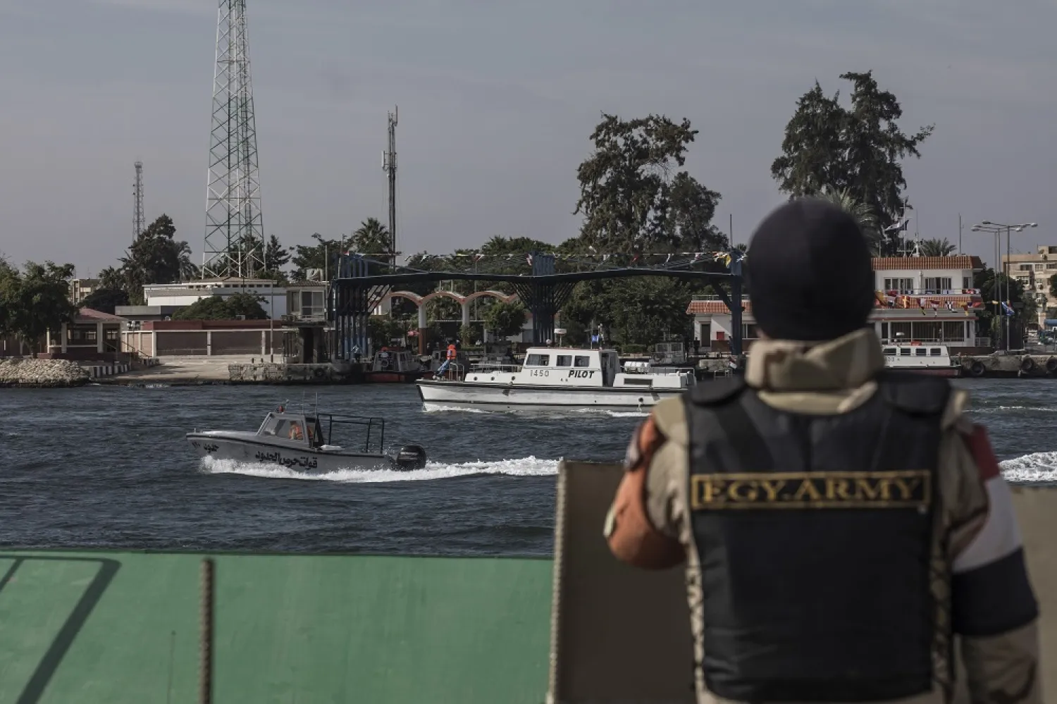 17 November 2019, Egypt, Ismailia: A soldier looks at boats as they sail down the Suez Canal, during celebrations marking the 150th anniversary of the Suez Canal. (dpa)